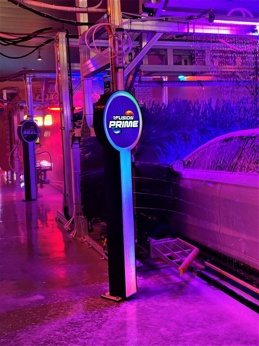 The Aqua Blue tunnel entrance sign glowing in blue
